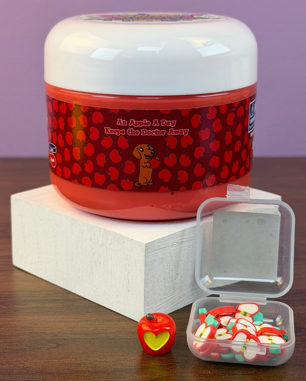 red ultra thick slime with an apple charm with fake apple clay sprinkles texture