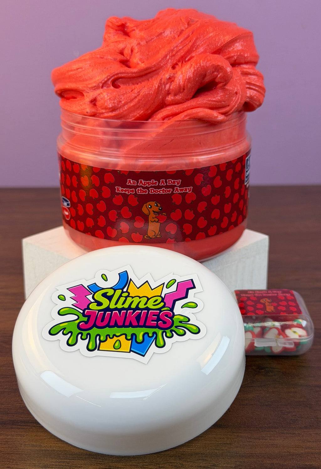 red ultra thick slime with an apple charm with fake apple clay sprinkles texture