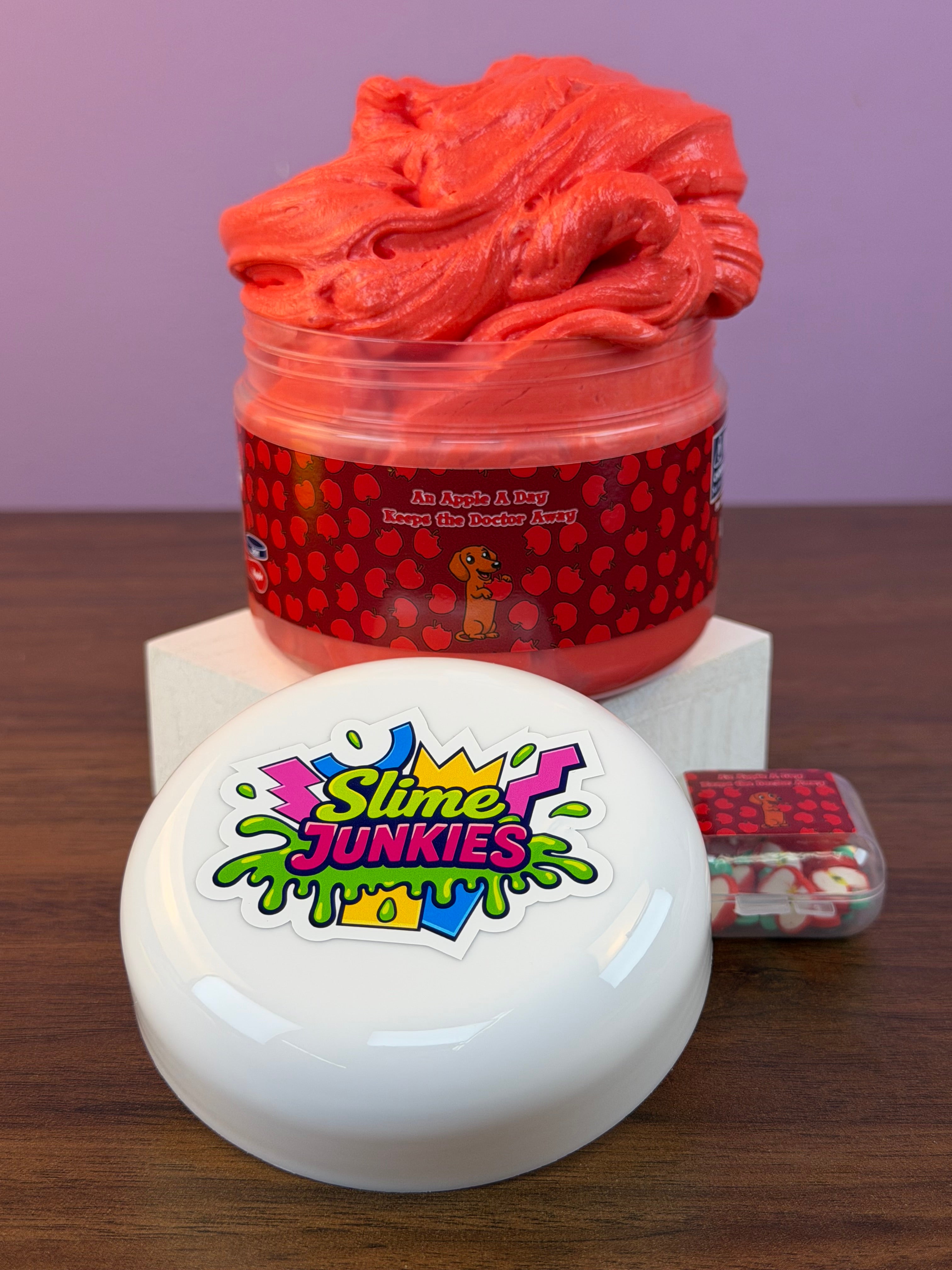 red ultra thick slime with an apple charm with fake apple clay sprinkles texture