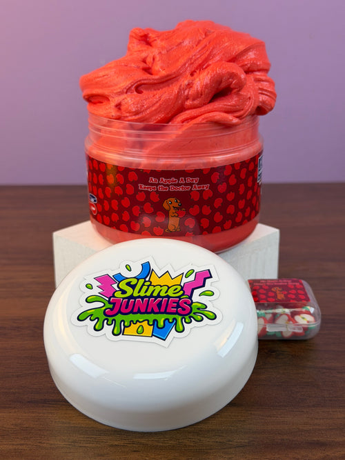 red ultra thick slime with an apple charm with fake apple clay sprinkles texture