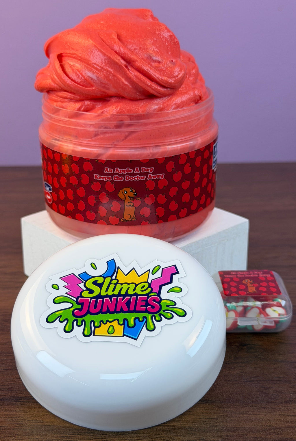 red ultra thick slime with an apple charm with fake apple clay sprinkles texture