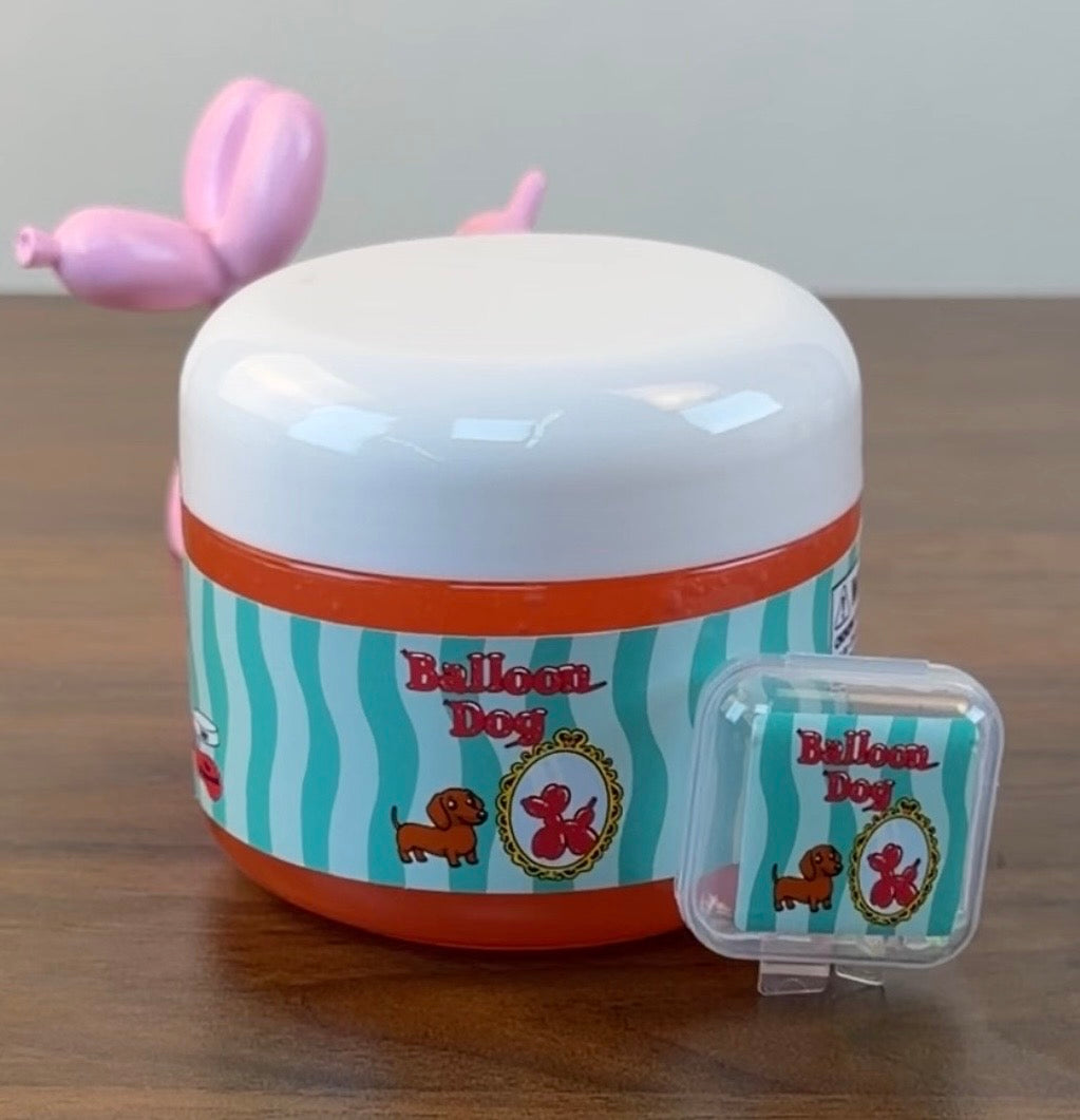 red coated clear slime with a plastic balloon dog charm with plastic balloon dog sprinkles