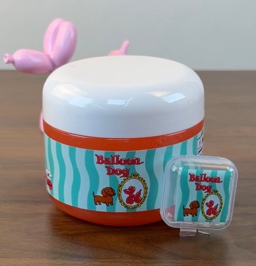 red coated clear slime with a plastic balloon dog charm with plastic balloon dog sprinkles
