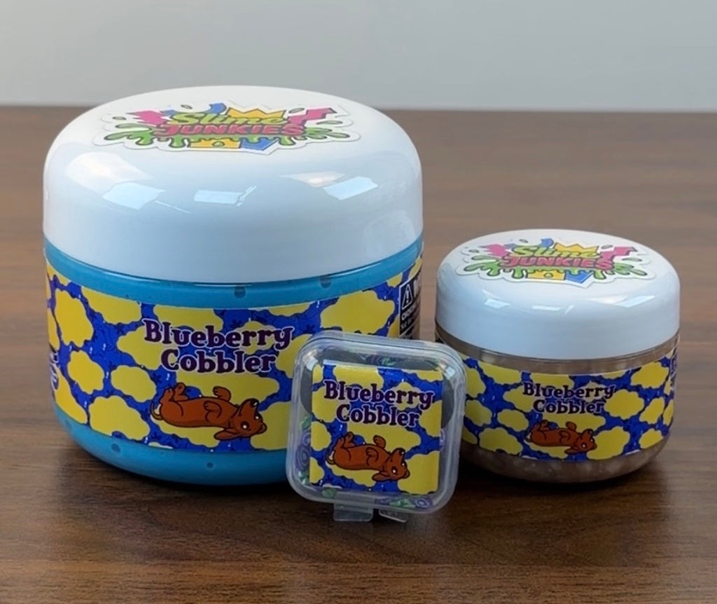 blue jelly slime with light tan perlite topper with fake plastic blueberries with fake blueberry sprinkles