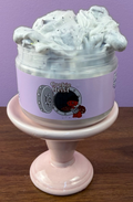 white slime with black glitter with fake oreo cookie charm with brown foam chunks texture