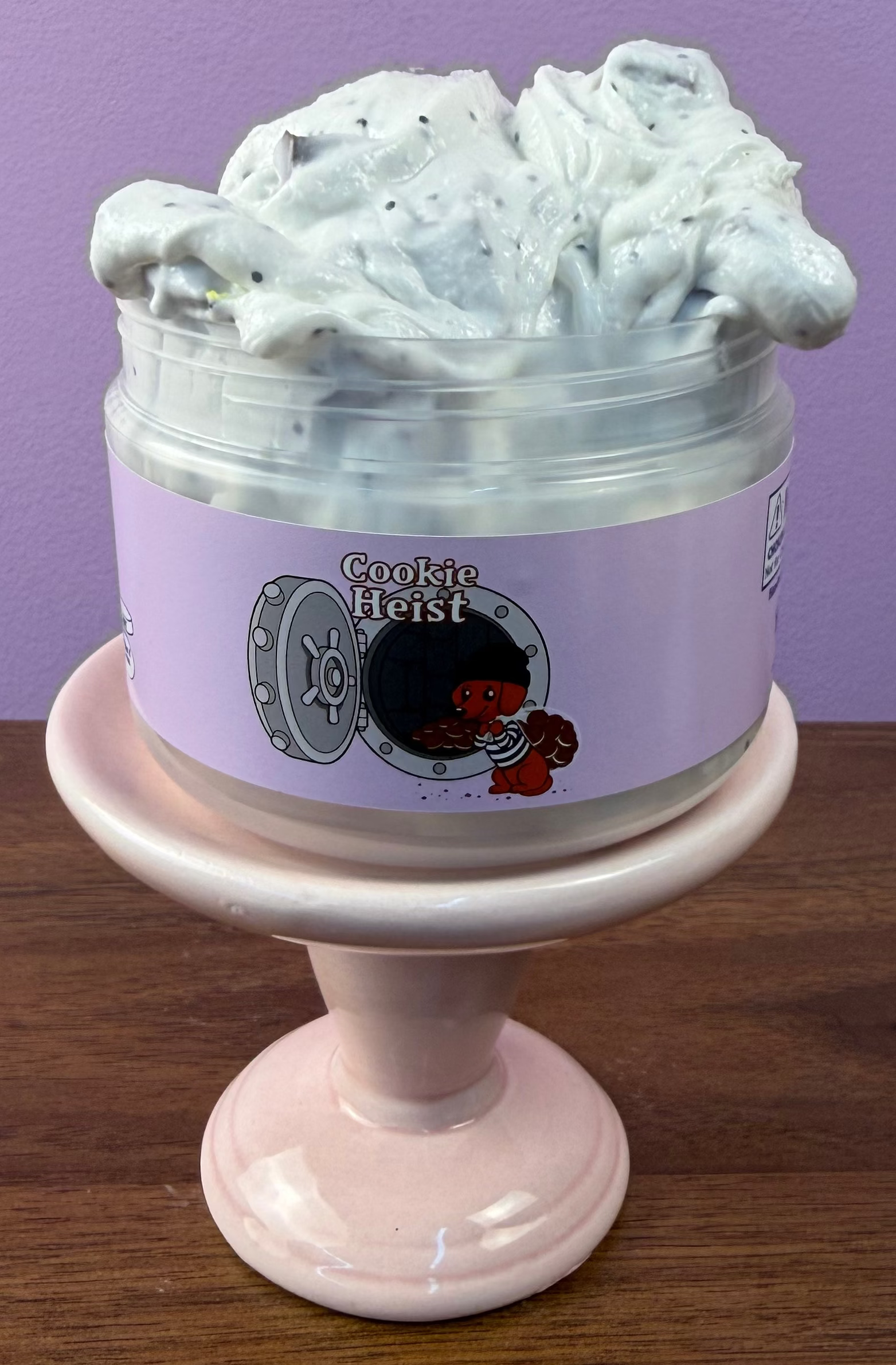 white slime with black glitter with fake oreo cookie charm with brown foam chunks texture
