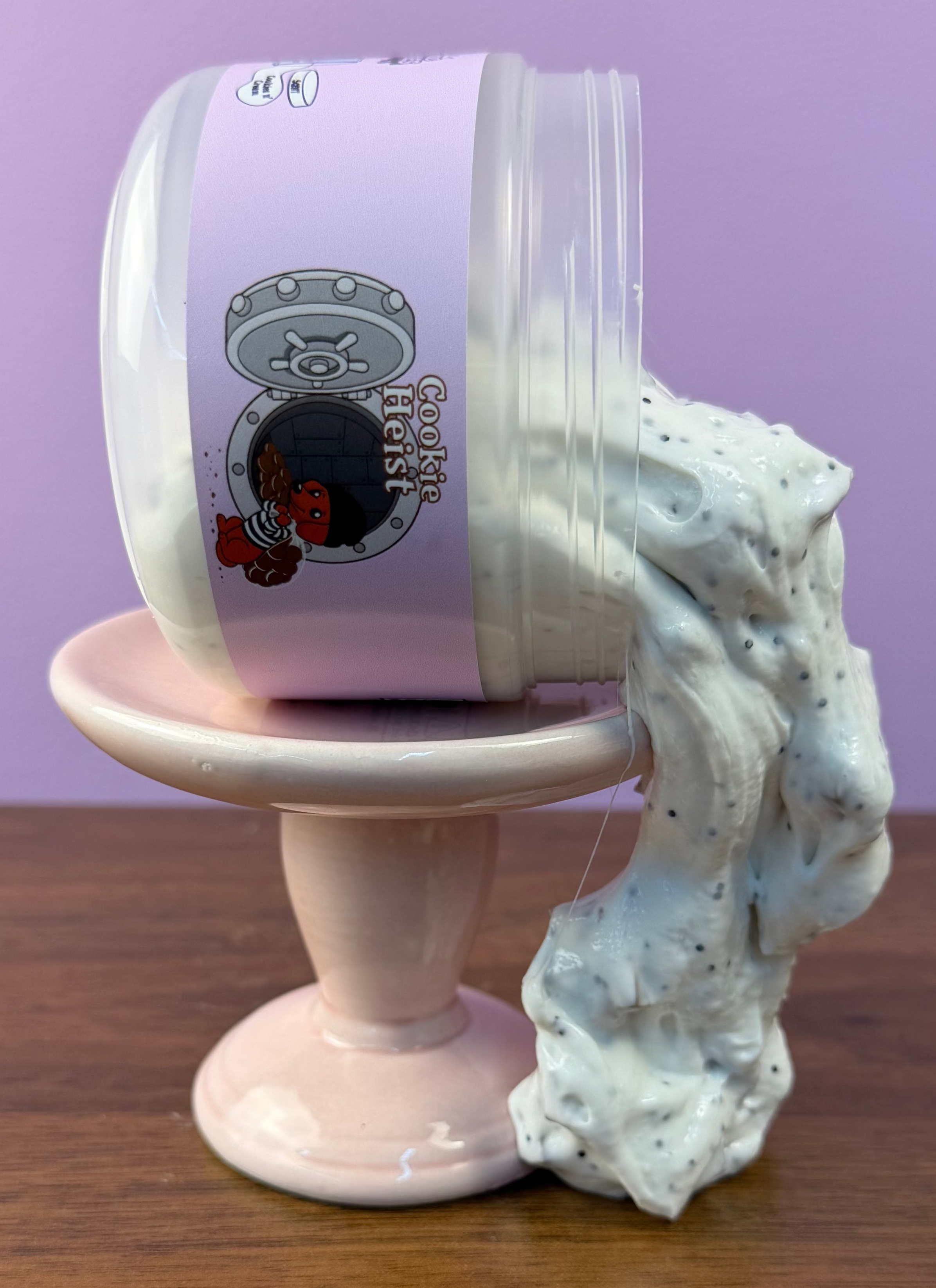 white slime with black glitter with fake oreo cookie charm with brown foam chunks texture