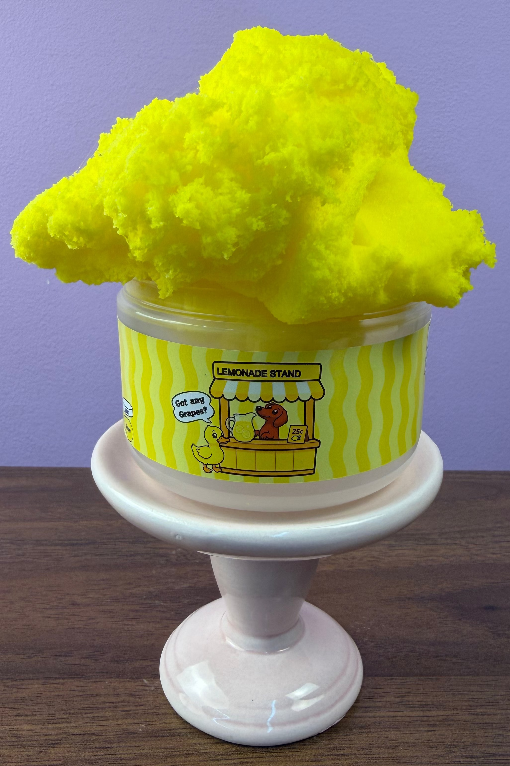bright yellow cloud slime with fake grape clay sprinkles with fake lemon clay sprinkles with fake plastic mini duck texture