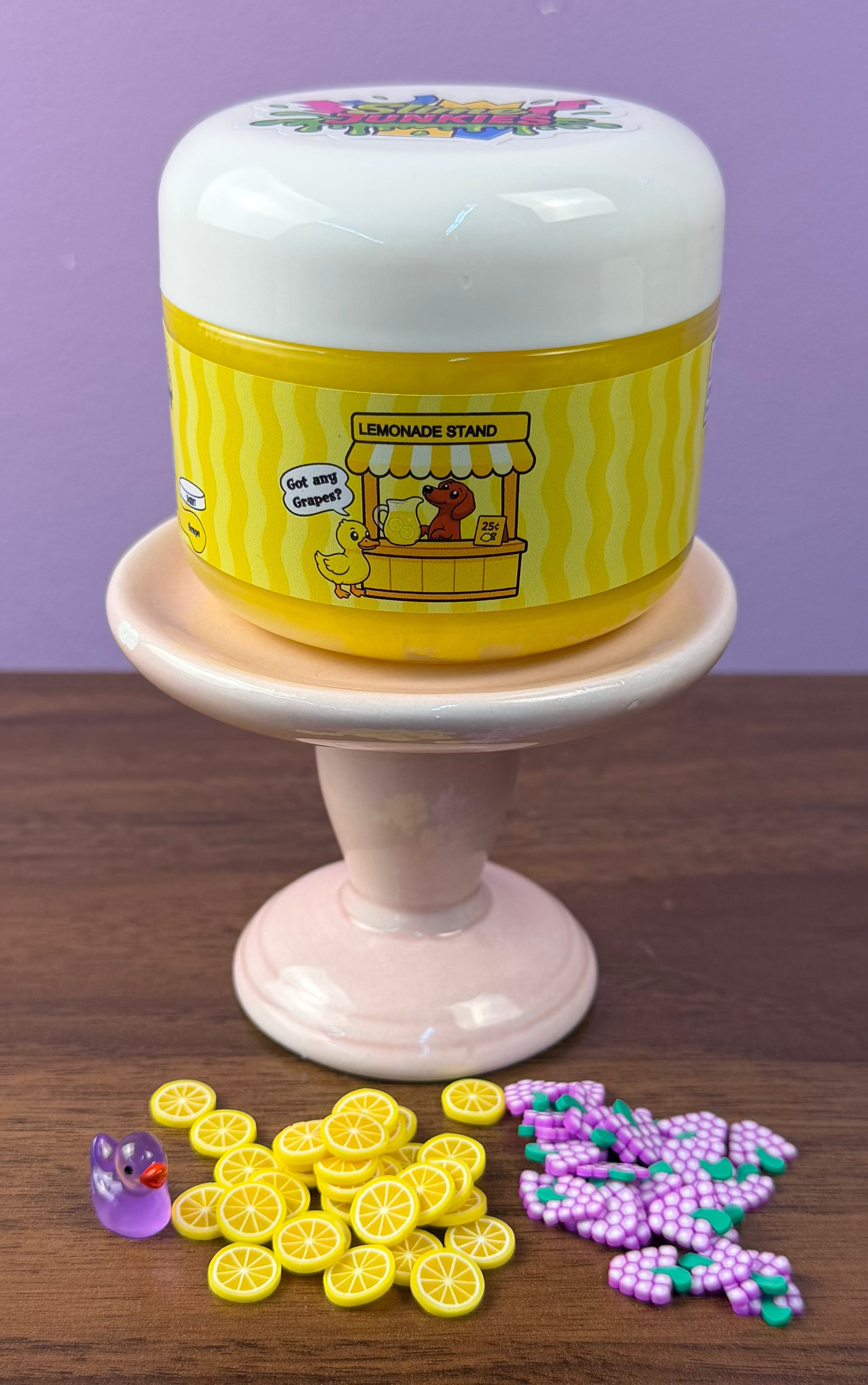 bright yellow cloud slime with fake grape clay sprinkles with fake lemon clay sprinkles with fake plastic mini duck texture
