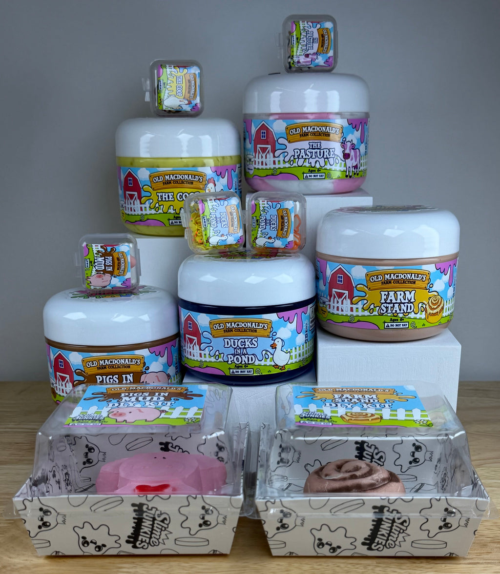 a collection of old macdonald slimes the coop, the pasture, farm stand, pigs in mud, and ducks on a pond all in clear jars with farm labels and animals to represent each label.