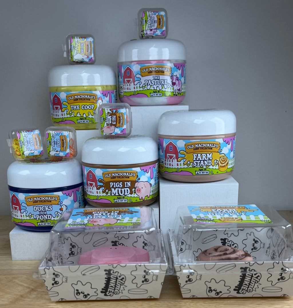 a collection of old macdonald slimes the coop, the pasture, farm stand, pigs in mud, and ducks on a pond all in clear jars with farm labels and animals to represent each label.