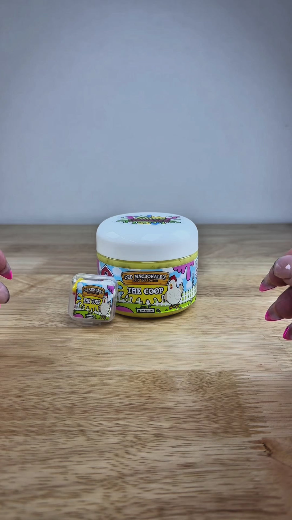 yellow slime with silica in a clear jar with a farm label that says old macdonald's farm collection the coop with a chicken topped with a chicken basket two eggs and a baby chicken