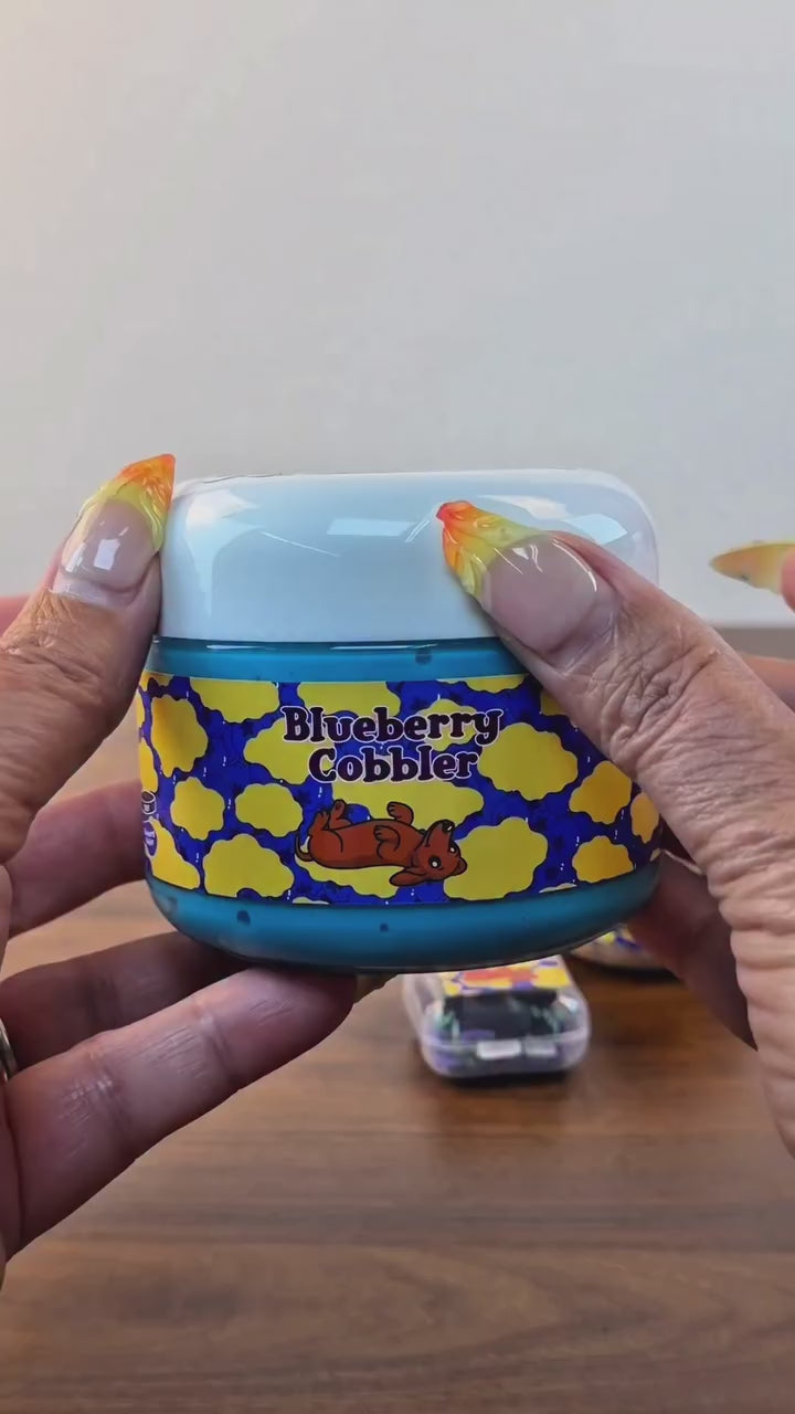 blue jelly slime with light tan perlite topper with fake plastic blueberries with fake blueberry sprinkles